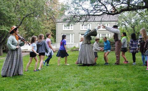 children learn traditional dance from history actors at Black Creek Village