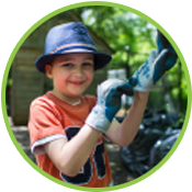 young boy wearing gardening gloves