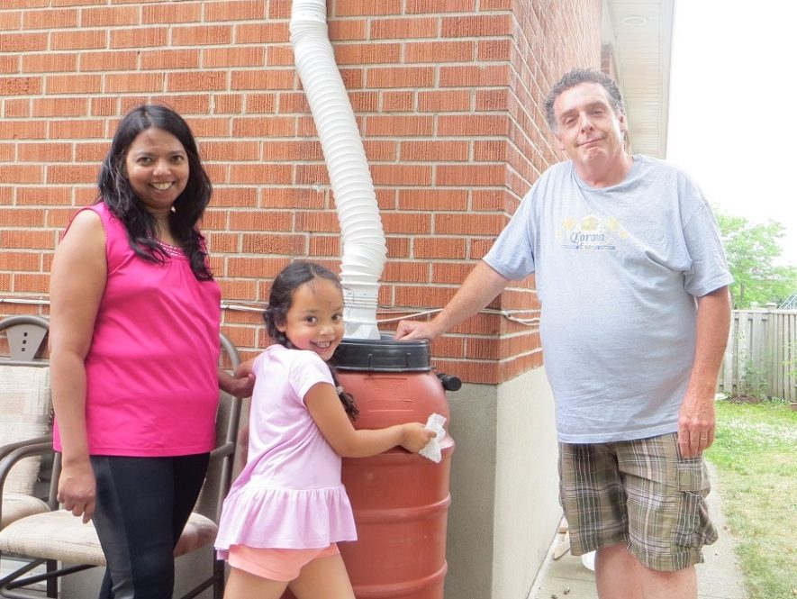 A family with a rain barrel
