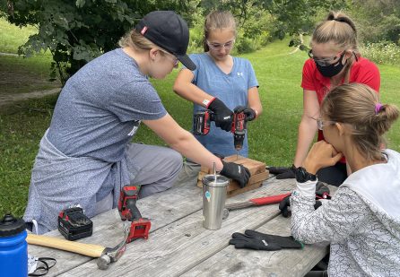 young women participating in Girls Can Too program learn to use power tools