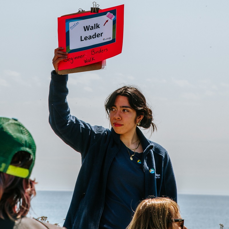 a student volunteer leads a trail walk at Tommy Thompson Park