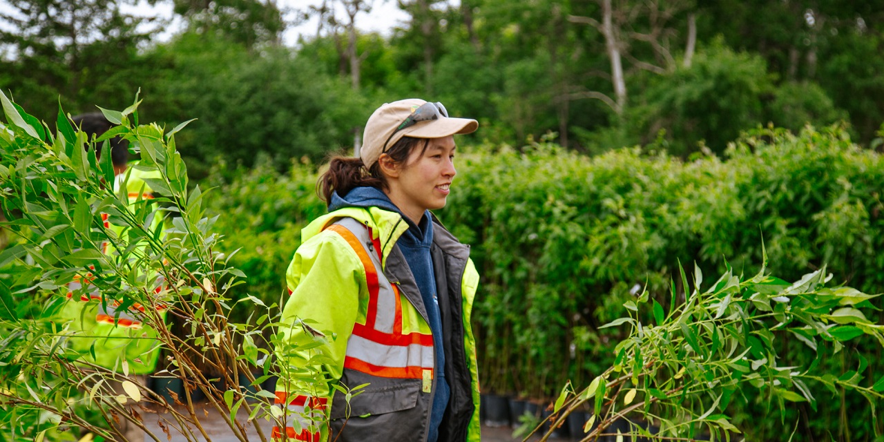 a young Restoration team member at the TRCA Nursery prepares for a planting